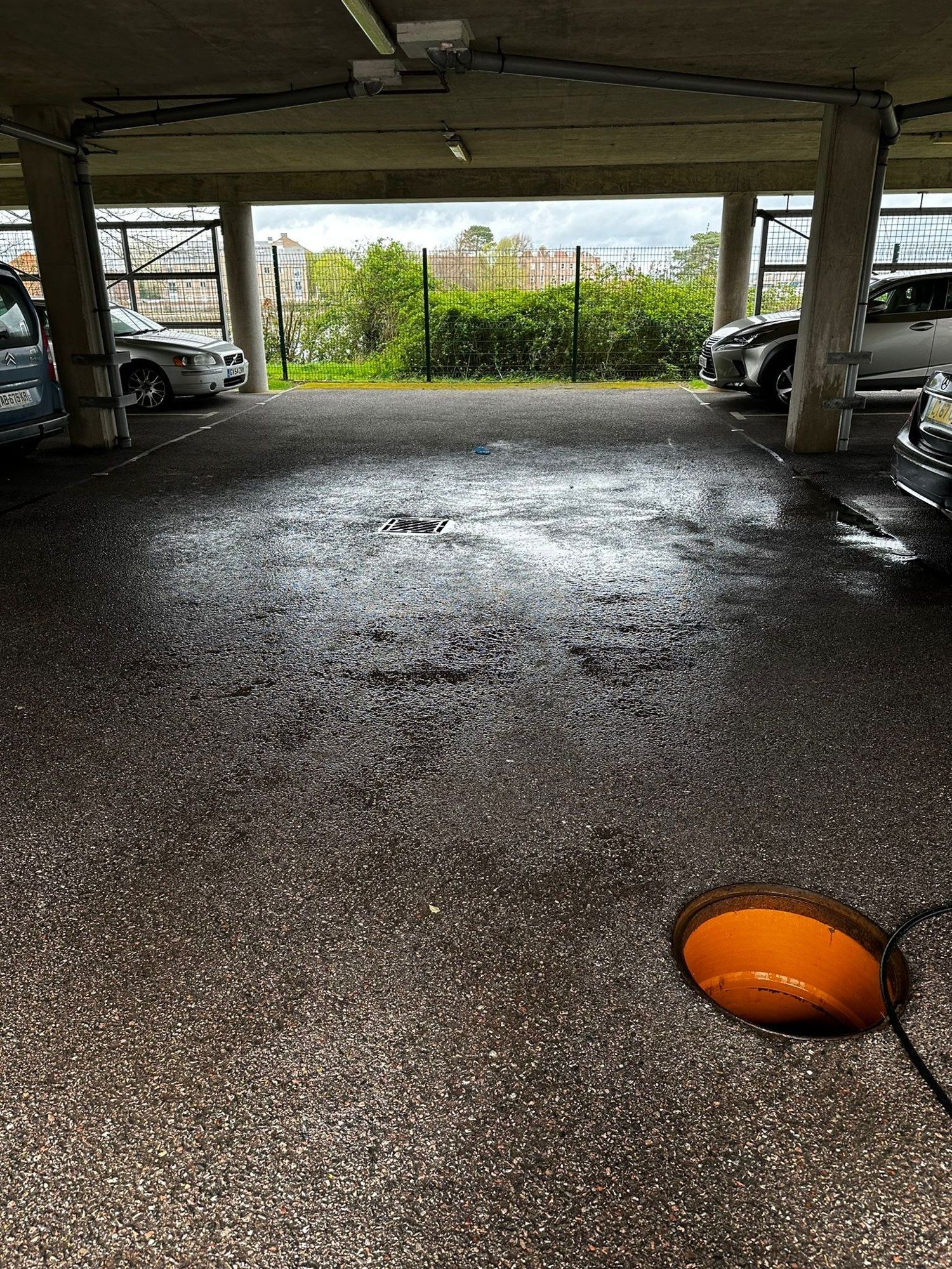 The same car park after the drain was cleared, the floor dry and the drain running